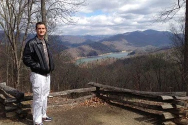 Photo of Greg T. Wallace standing in the mountains of North Carolina.